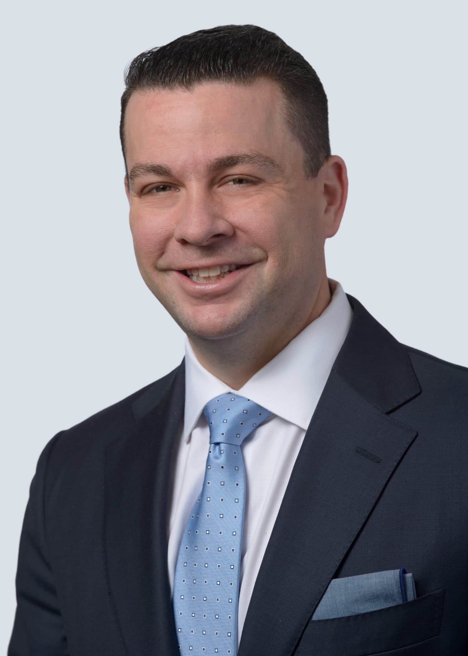 Accessible, professional portrait of Justin Ackerman in a suit, representing NAHMA and affordable ho.