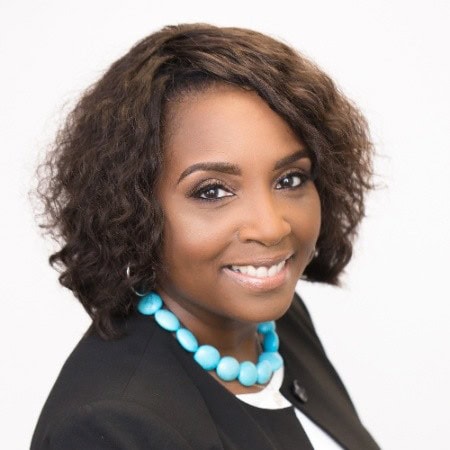 Affordable housing advocate Lisa McCarroll, smiling, wearing a black blazer and turquoise necklace.