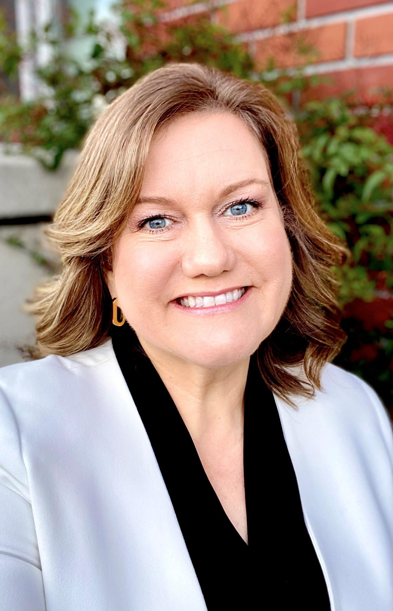 Affordable housing advocate Jennifer Wood smiling outdoors, promoting NAHMA's mission.