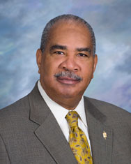 Senior professional portrait of Michael Simmons, NAHP-e, emphasizing housing and real estate experti.